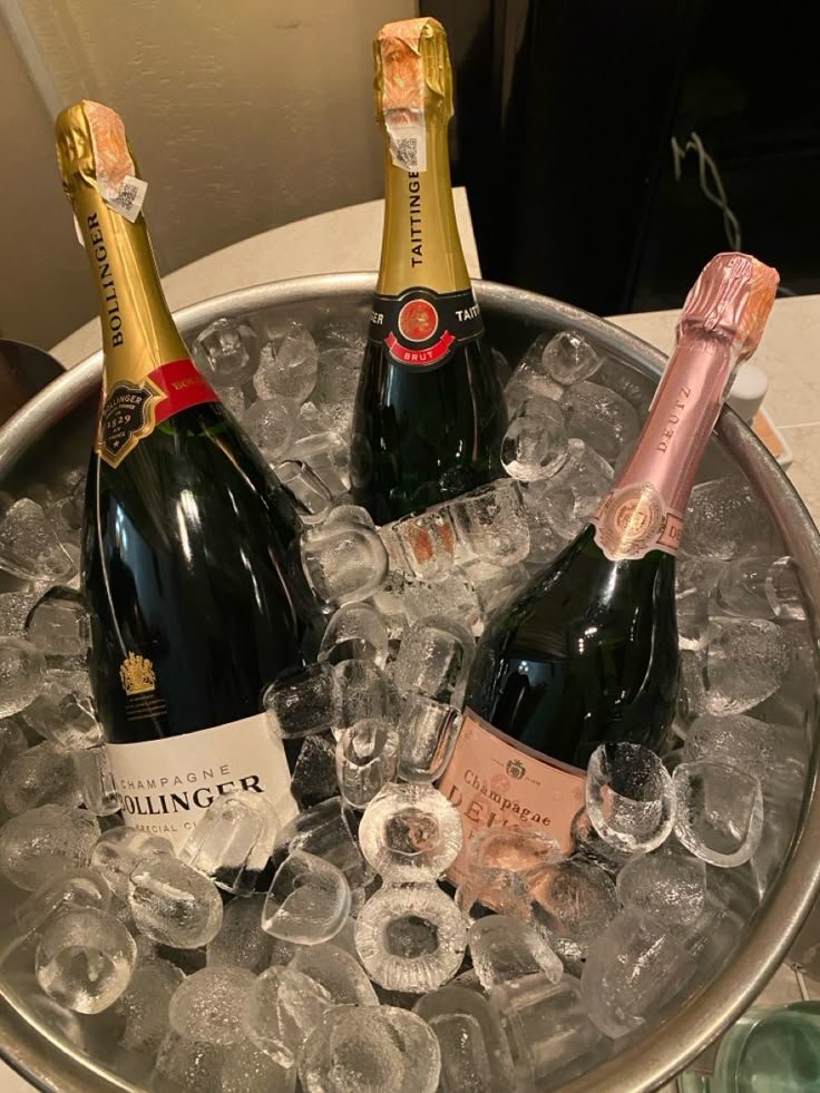 Sparkling bottles resting in an ice bowl