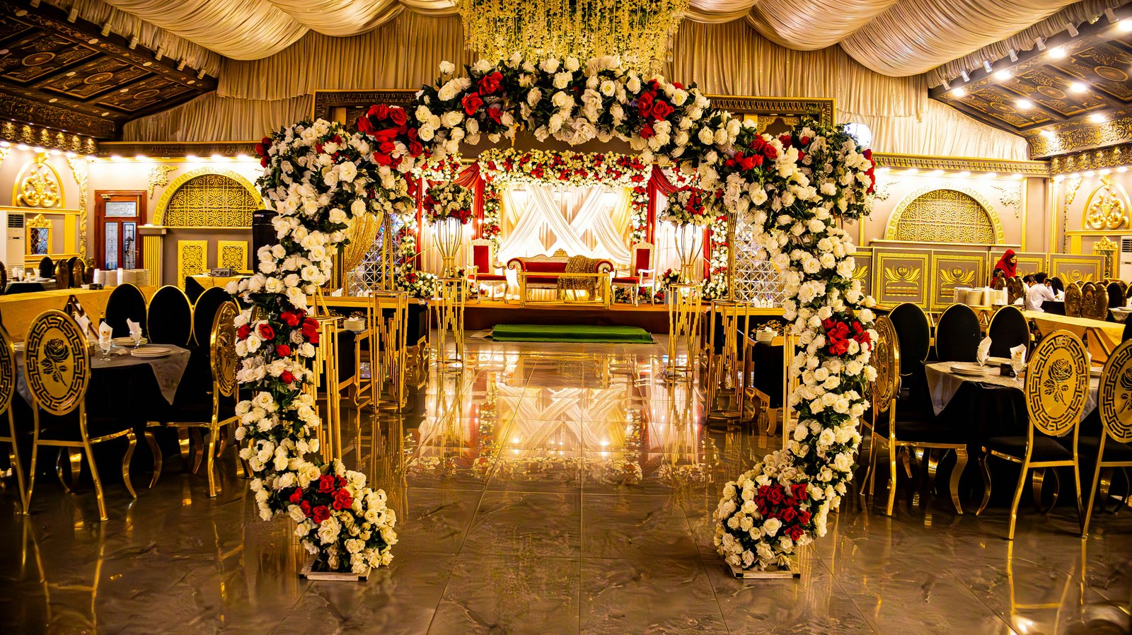 Floral arch leading to a wedding stage